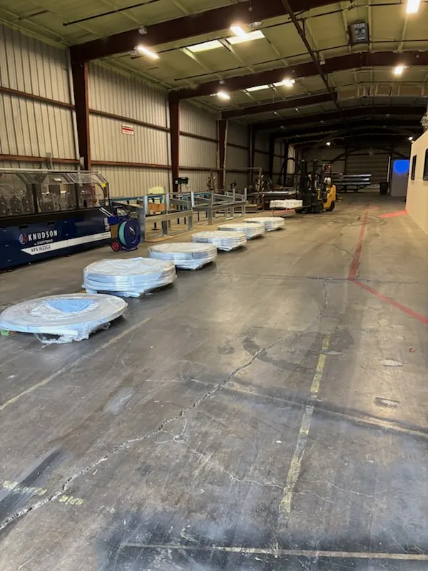 Knudson roll former and steel coils staged in the NonCombustibles warehouse