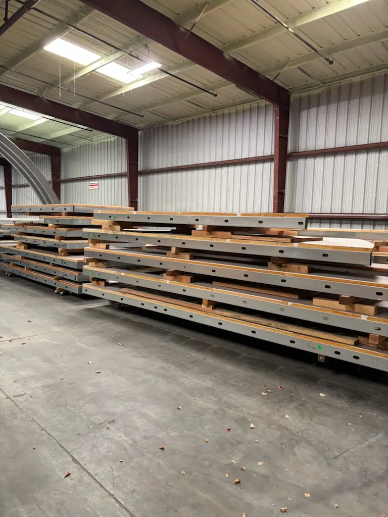 Stacked steel-framed wall panels staged for shipment